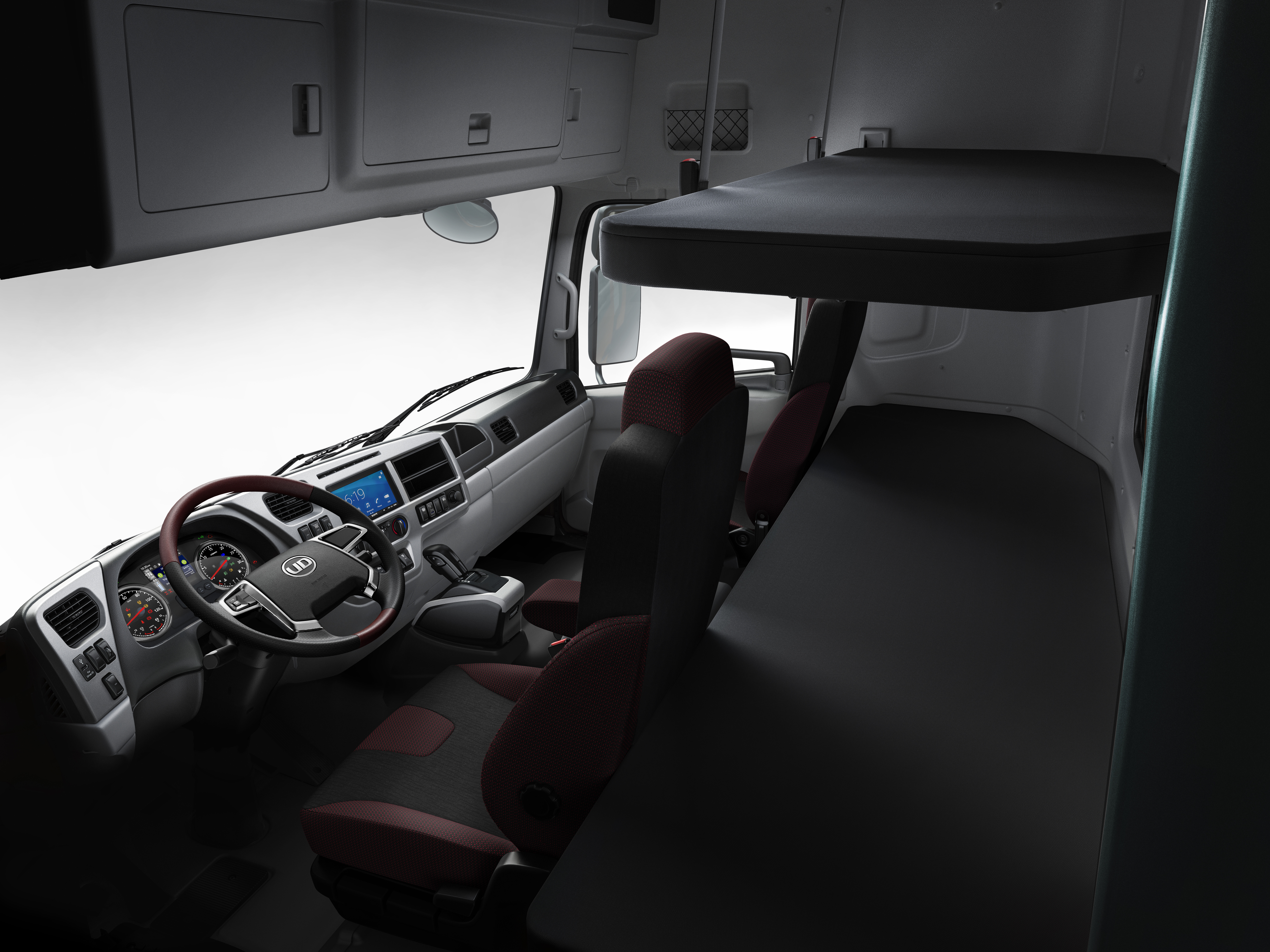 Quester Truck cabin interior with two seats, overhead compartments, and a sleeping bunk.