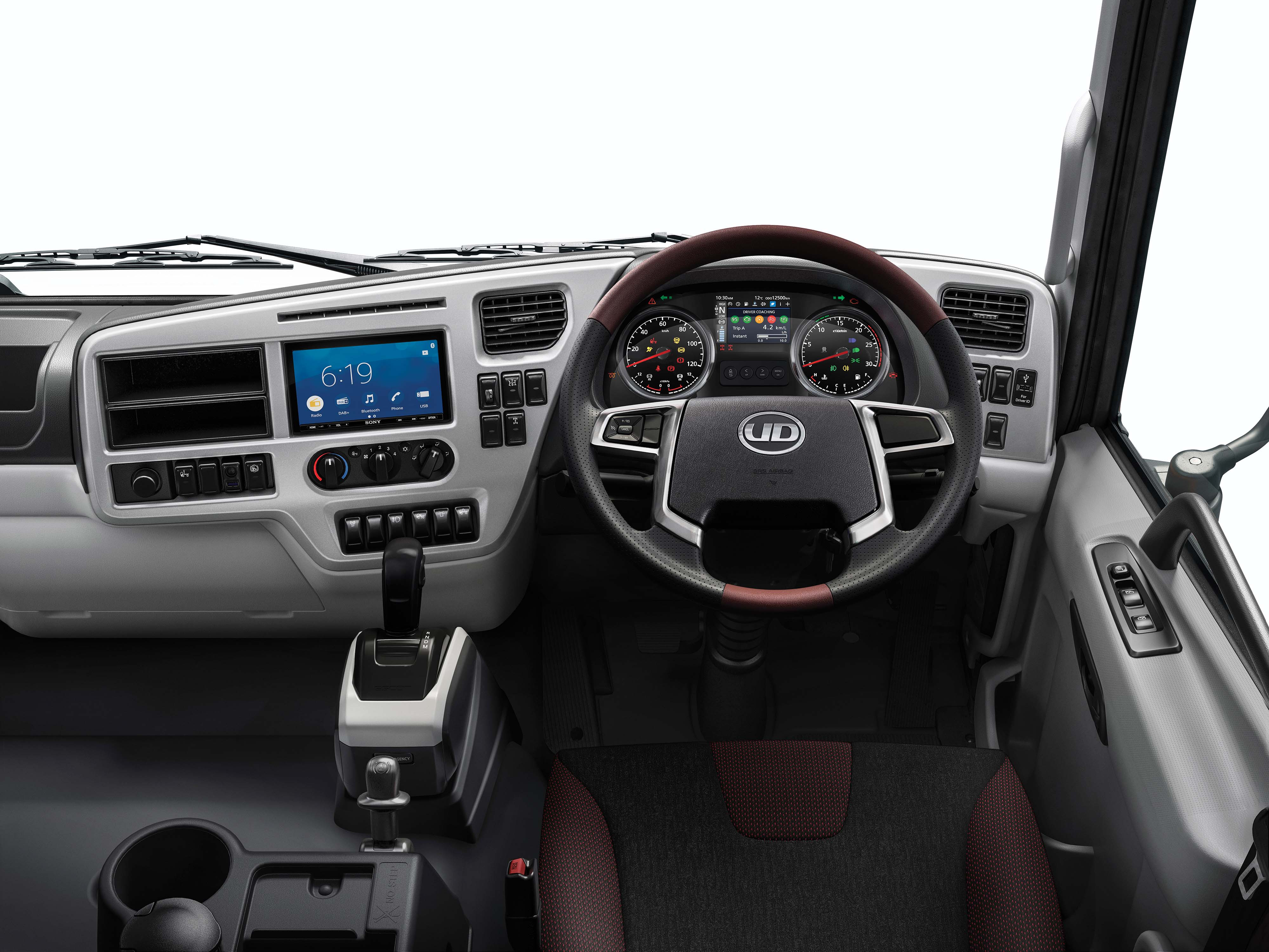Modern truck cockpit with digital display, steering wheel, and dashboard controls.