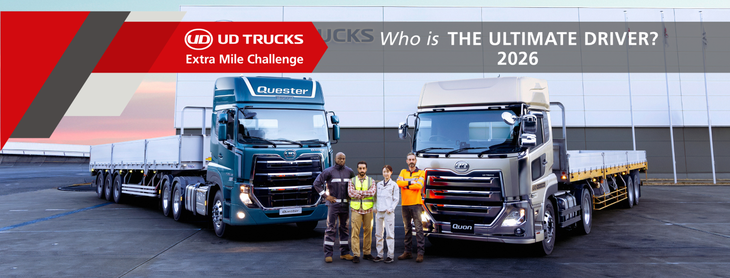 Two large trucks parked side by side with five people standing between them.